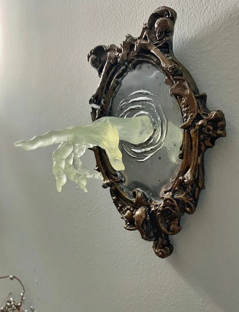 SPOOKY WALL SCULPTURES OFVICTORIAN GHOSTS EMERGINGFROM A MIRROR