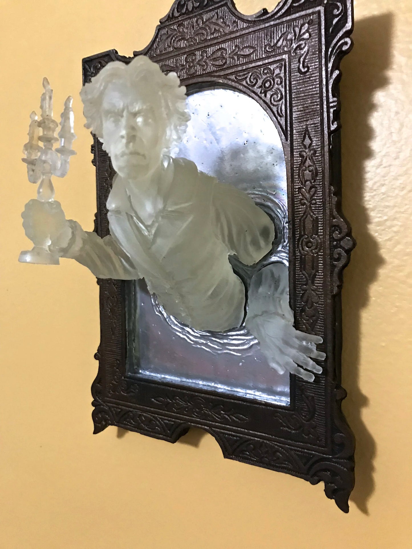 SPOOKY WALL SCULPTURES OFVICTORIAN GHOSTS EMERGINGFROM A MIRROR